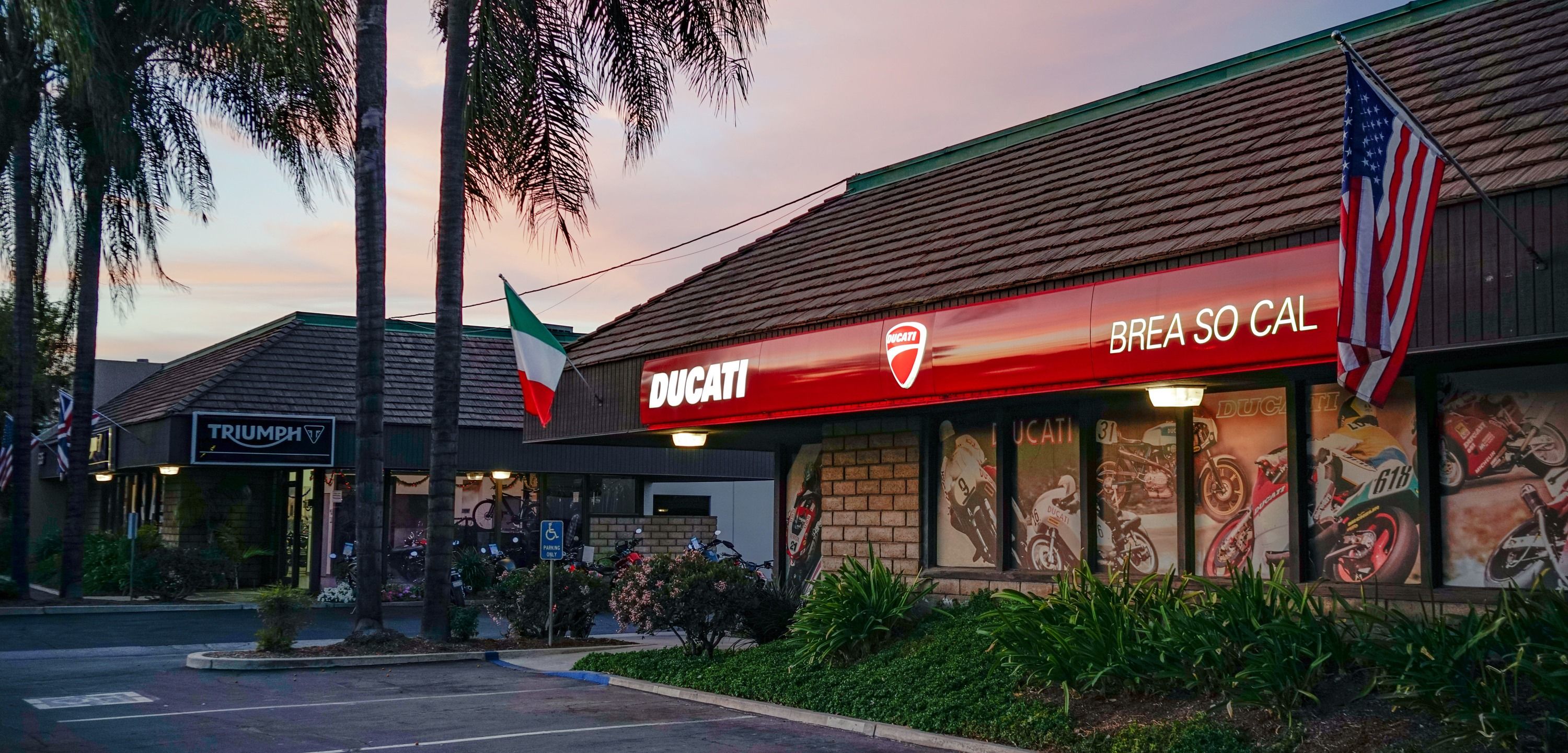 The Southern California Motorcycles storefronts on West Lambert Road at dusk.